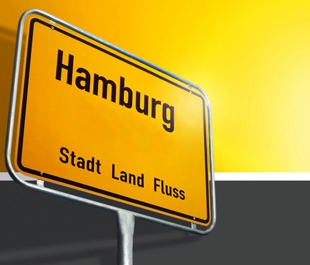 Sie sehen ein gelbes Ortsschild mit der Aufschrift "Hamburg".